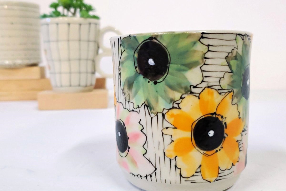 handcrafted mug with flowers on it 