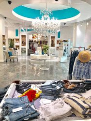 Beautiful women's clothing boutique featuring our circle settee sofa